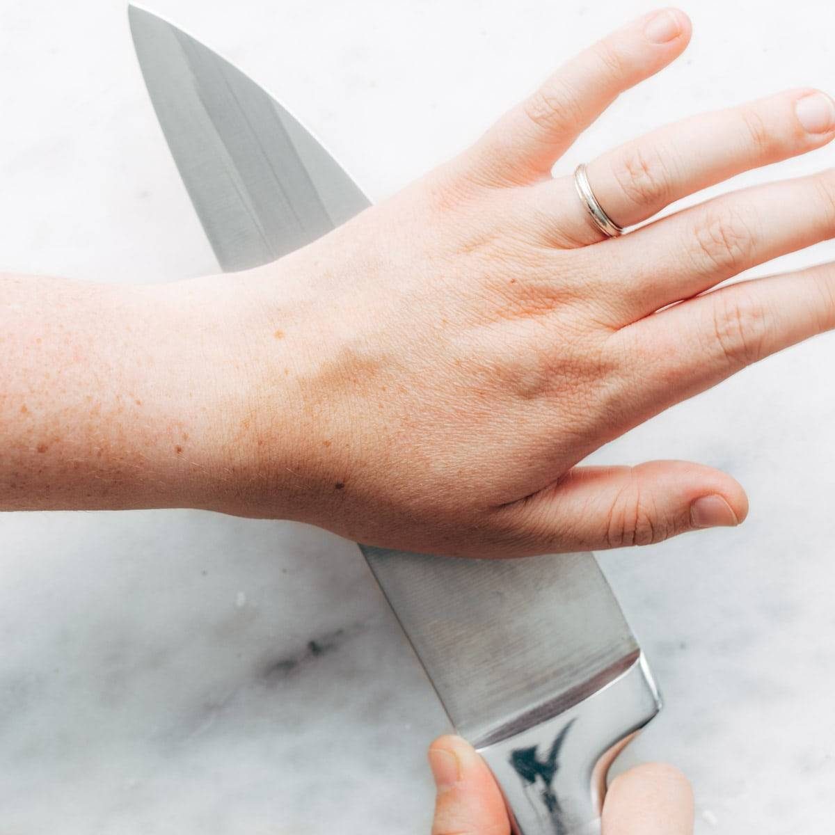 Smashing Garlic with a knife.