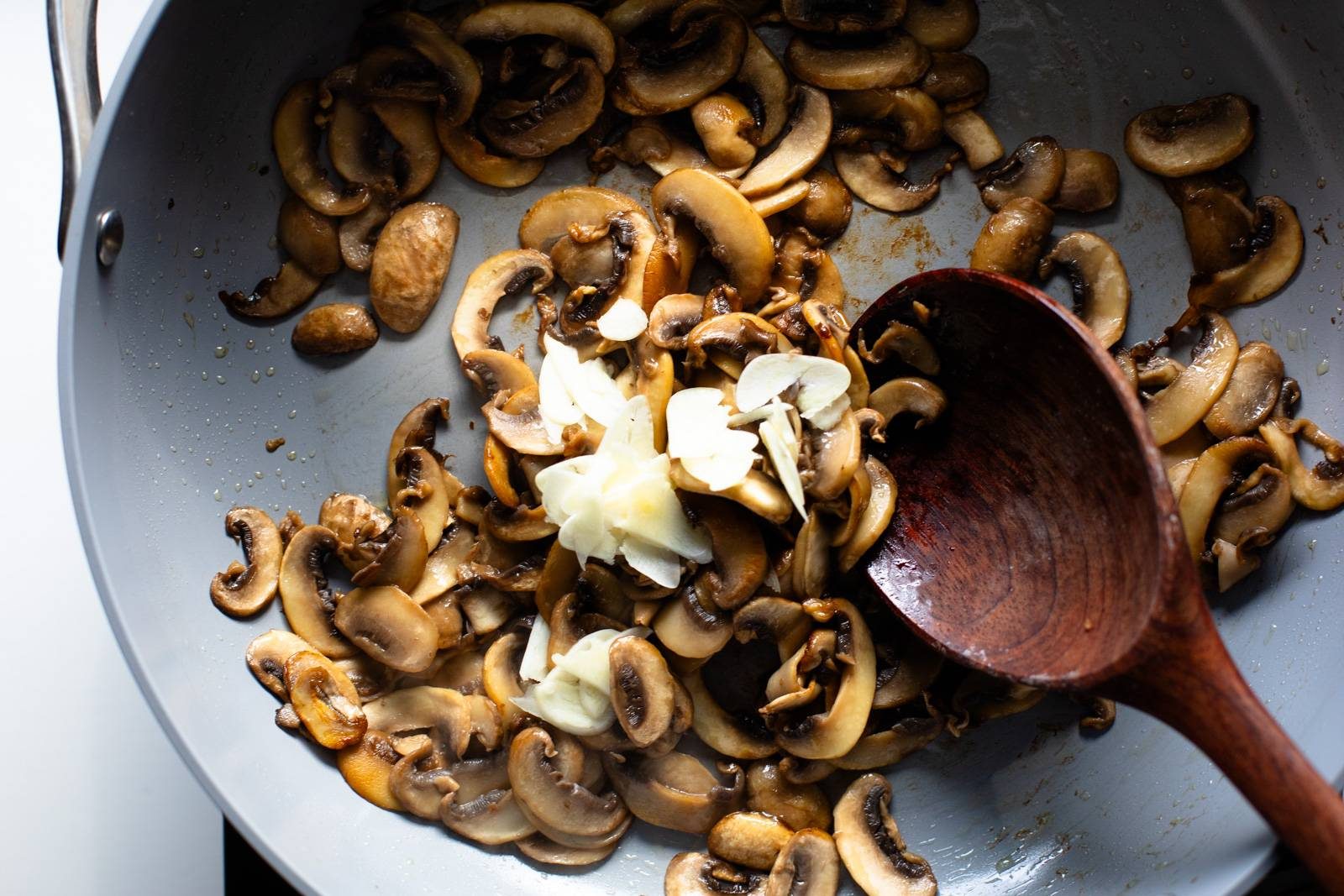 Mushrooms and garlic in a pan.