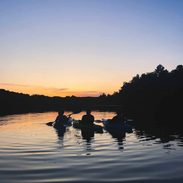 People canoeing at sunset.