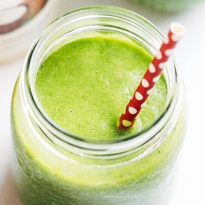 Simple Coconut Green Smoothie in jars with straw.