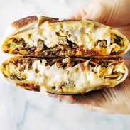 Breakfast Crunchwrap held in a hand.