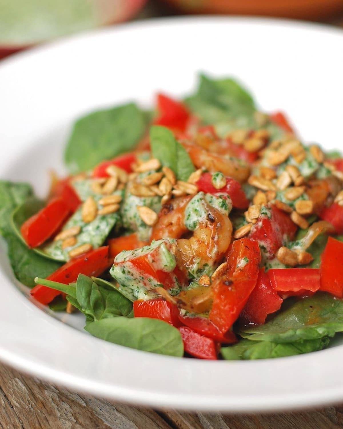 This healthy Spicy Southwestern Salad recipe has roasted sweet potatoes, black beans, corn, lettuce, and creamy avocado dressing! | pinchofyum.com