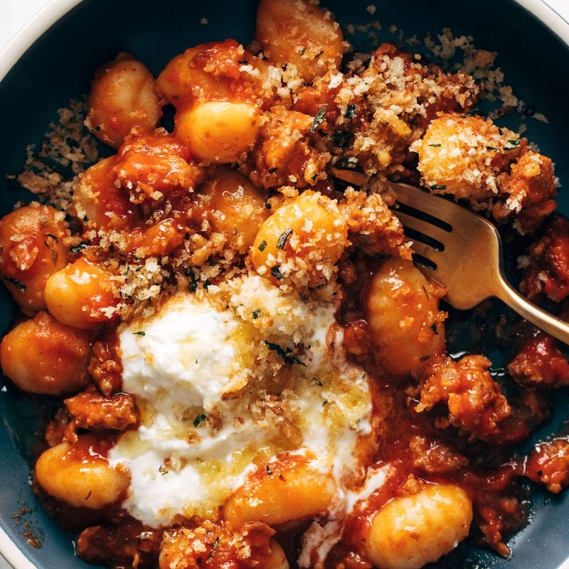 Gnocchi with red sauce and ricotta in a bowl.