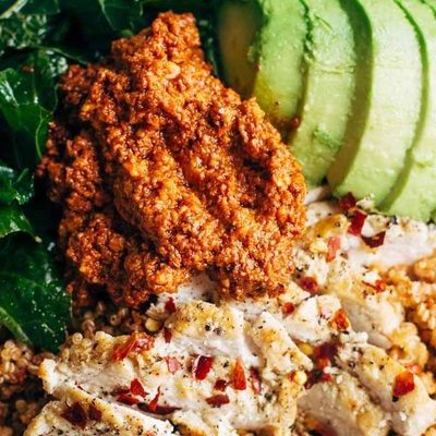 Kale and Chicken bowls with avocado and sauce.