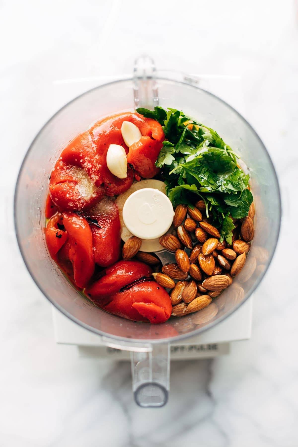 Red pepper sauce ingredients in a food processor.
