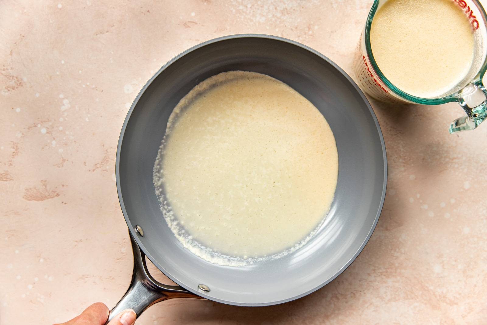 Adding batter to a pan.