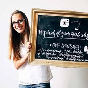 Lindsay holding a chalkboard for the Tasty Food Photography workshop.