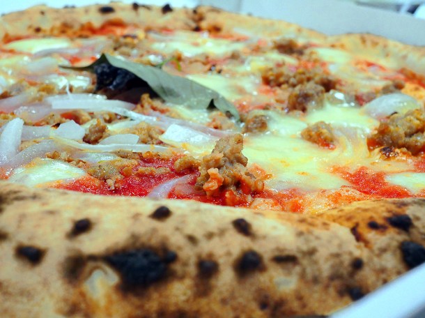 illustrative photo of the sausage and onion pizza from Theo's
