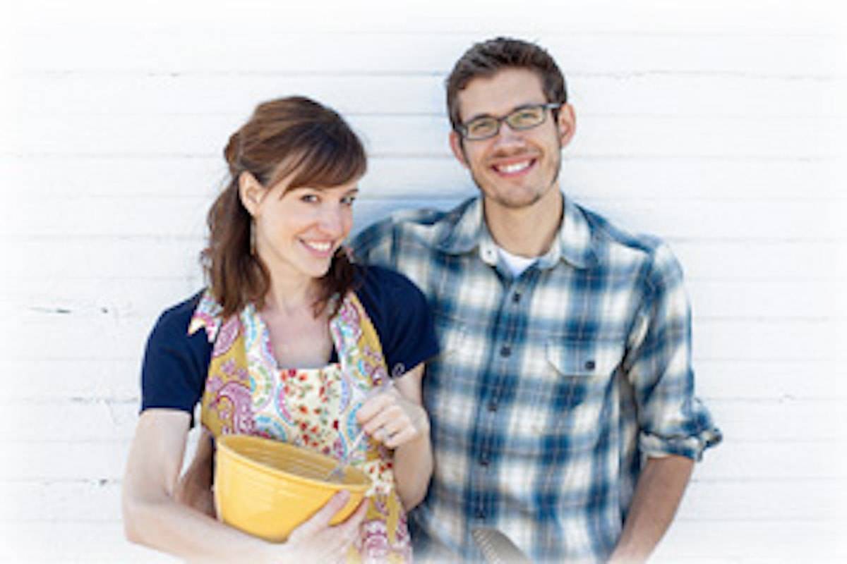 Man and woman smiling at camera.