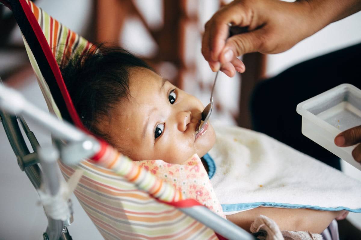 Young child being fed.