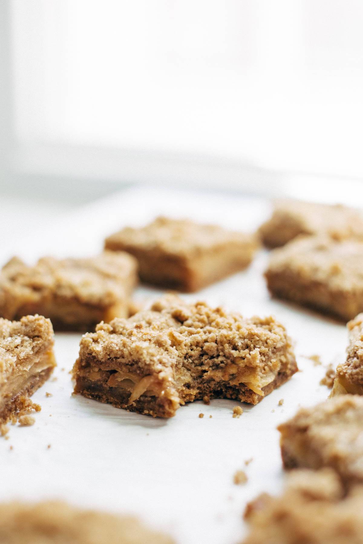 These layered bars are so simple! Loaded with homemade caramel and apples. Caramely apple layer tucked in by a brown sugar-y crust on both sides. | pinchofyum.com