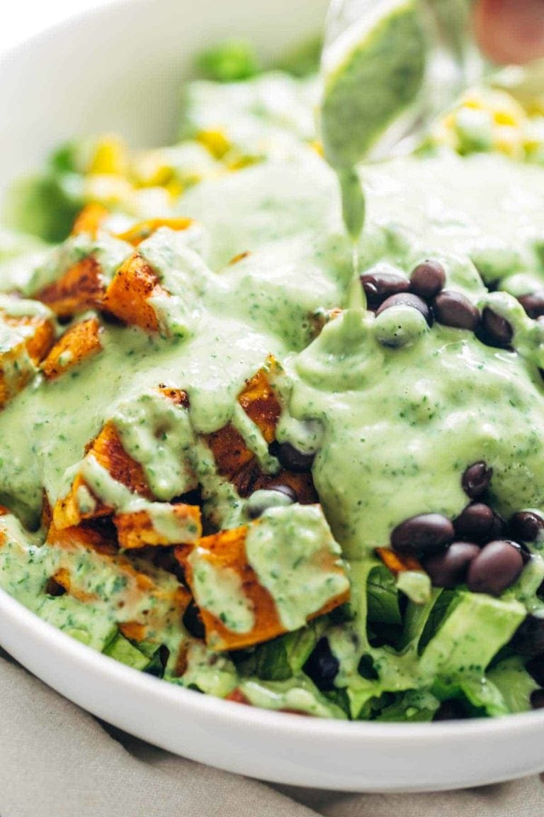 Avocado cilantro dressing poured on a salad.
