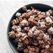 Big bowl of puppy chow being set down by a white hand.