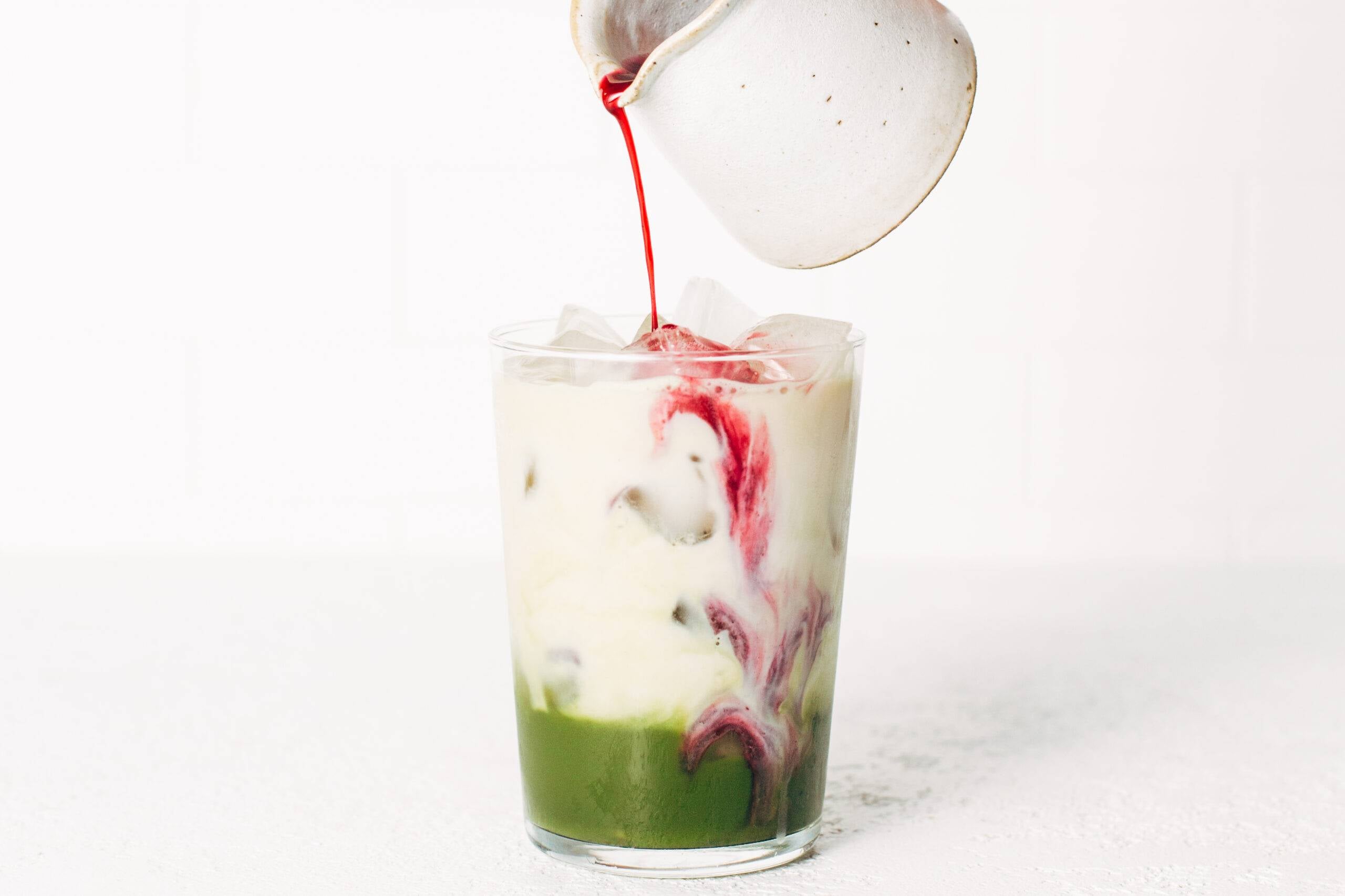 Blueberry syrup added to the matcha and oat milk