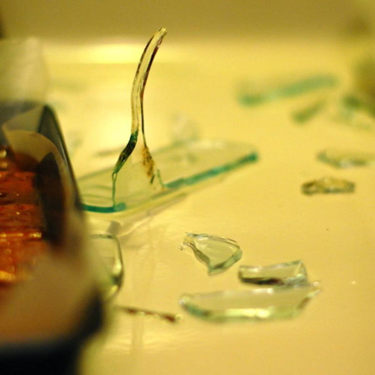 Pieces of broken glass on a smooth surface.