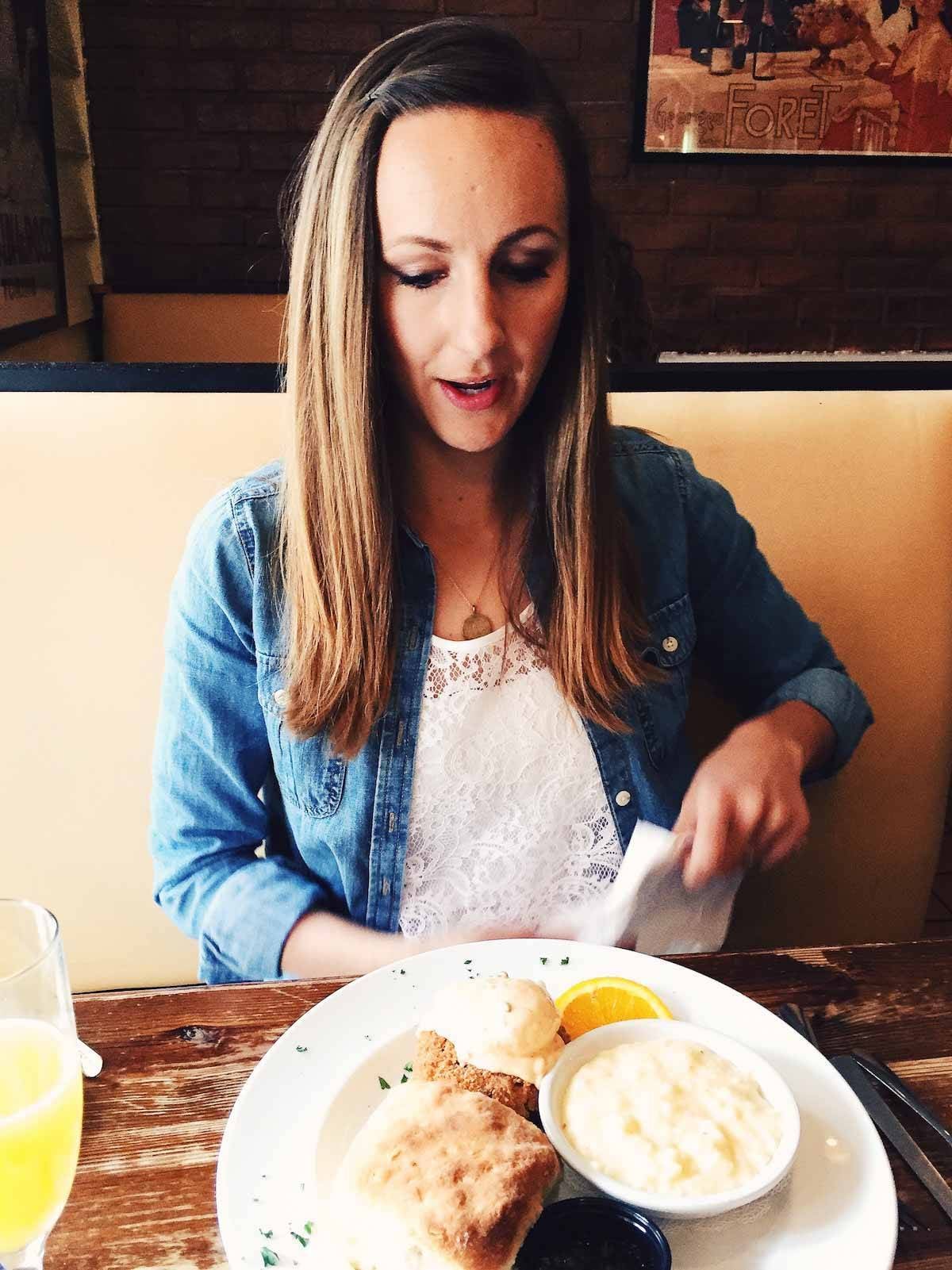 Woman at a table eating.